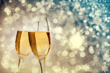 Champagne glasses on sparkling background