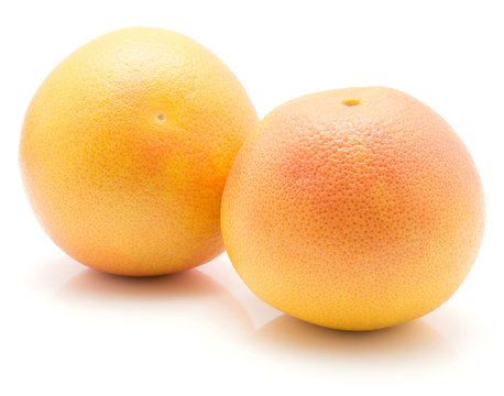 Red grapefruits isolated on white background two whole.