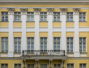 Fototapeta premium The facade of a historic building with pillars and decorated with bas-reliefs in St. Petersburg