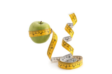 Green apple and measuring tape on a white background