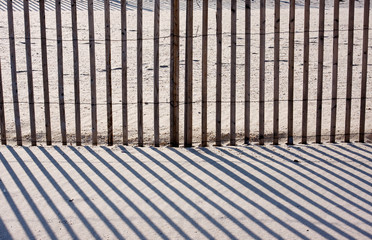 Fence, Sand, and Shadows