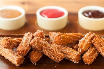 churos with dulce de leche, raspberry and chocolate dipping sauce