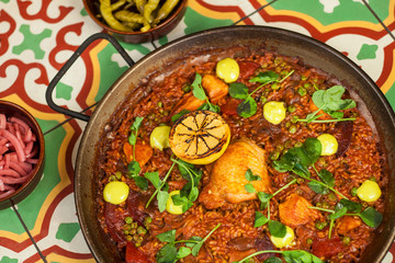 chorizo and pollo paella on a tile tabletop