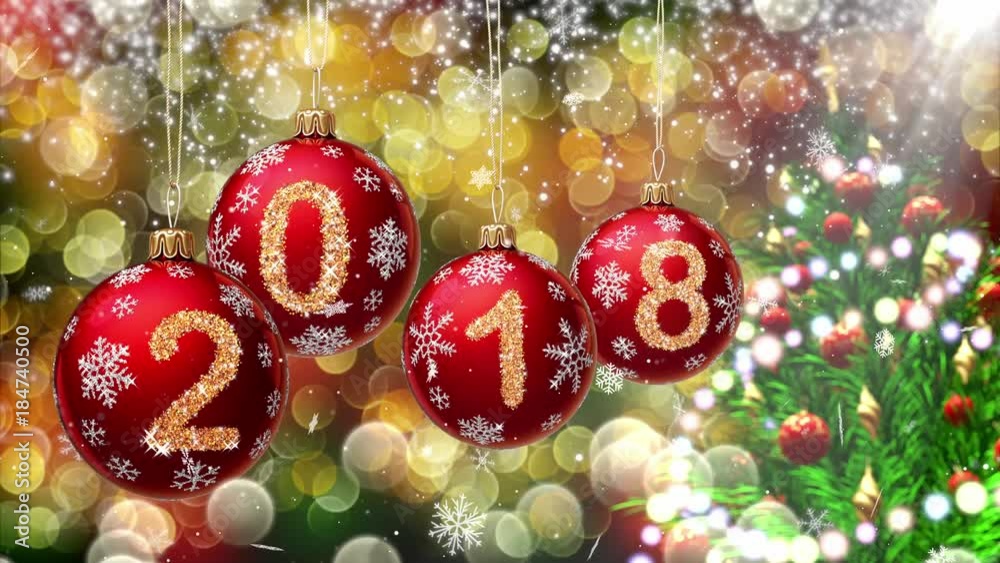 Sticker red balls with numbers 2018 hanging on the background of a bokeh and a rotating christmas tree. 3d r