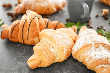 Delicious sweet croissants on table