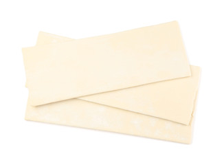 Raw puff pastry on white background