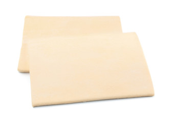 Raw puff pastry on white background
