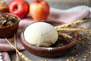 Dish with raw puff pastry and spikelets on table