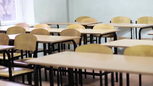 Empty rural classroom with writing desks and chairs