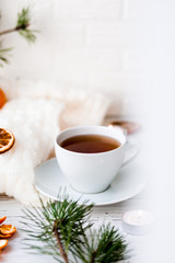 Winter breakfast. Tangerine and a cup of tea. Tree and the candles on the windowsill. Christmas morning 