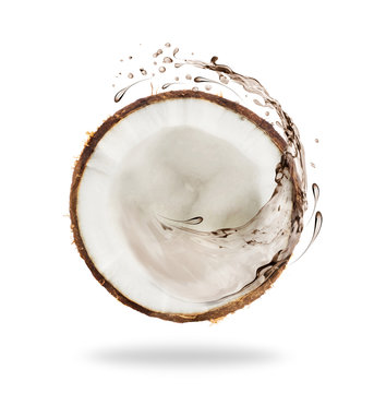 Piece of cut coconut with splashes of juice, isolated on white background