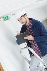 service technician writing the information on emergency signal