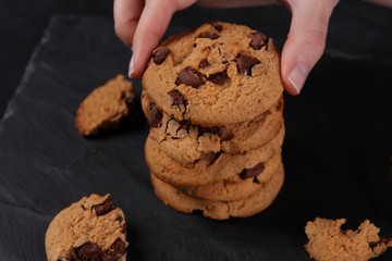 Woman arranging Christmas chocolate chip cookies close up. Baking at home concept
