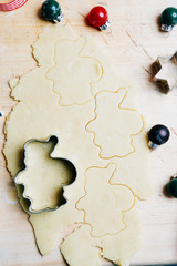 Preparing Christmas cookies as gift, with christmas decoration and wooden background, top view.
