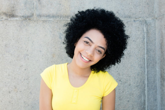 Portrait of a beautiful young adult woman with curly black hair