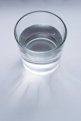 A glass of water on a light background