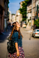 Obraz premium Happy girl walking along the street