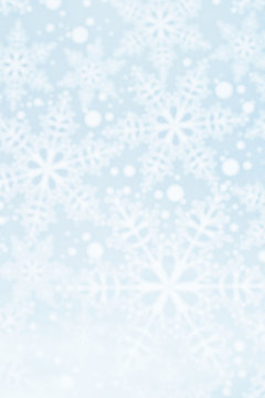 Light defocused winter background with blue snowflakes, vertical image