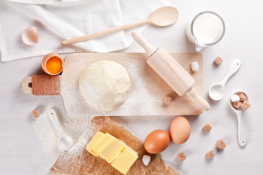 Dough preparation recipe for bread, pizza, pasta, cookies or pie ingridients, food flat lay on kitchen table background. Working with butter, milk, yeast, flour, eggs, sugar pastry or bakery cooking.