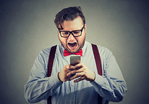 Man having annoying problems with smartphone
