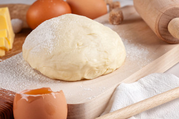 Dough preparation recipe for bread, pizza, pasta, cookies or pie ingridients, food flat lay on kitchen table background. Working with butter, milk, yeast, flour, eggs, sugar pastry or bakery cooking.