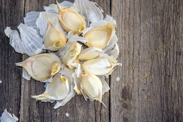 Separated portions of garlic on a rustic wooden surface