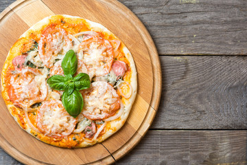 Colorful pizza with mozzarella cheese, chicken, sweet pepper and parsley close up top view. Italian cuisine home cooking. toned image 