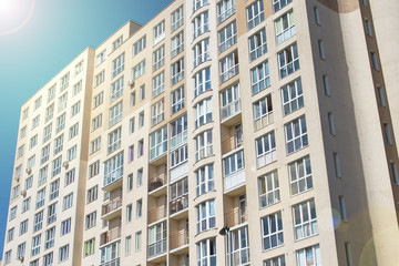 Many windows in the wall of the apartment house