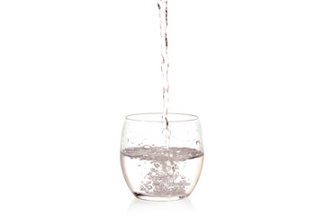 Glass of water pouring water splashing drops 