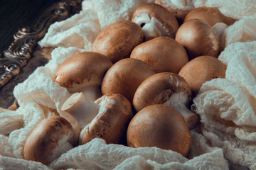 fresh brown mushrooms in a napkin decorated on a plate