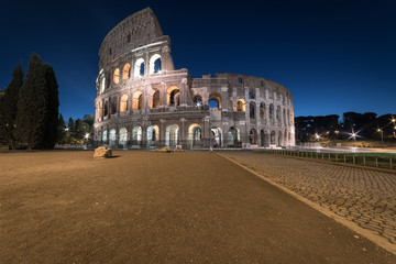 Colosseum at twilight, Rome, Italy, Europe. Ancient arena of gladiator fights. Colosseum is the most important landmark of Rome and Italy.