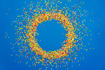 Colored confetti on a blue background. Party, Birthday, New Year.