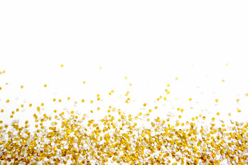 Golden shiny confetti on a white background.