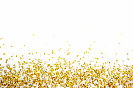 Golden Shiny Confetti On A White Background.