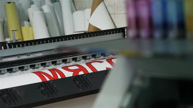 Closeup Wide Format Printer with Print Head Displaying Title