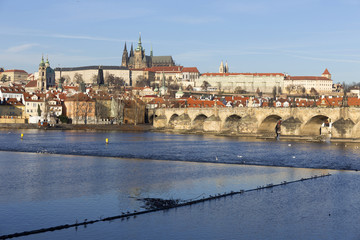 View on the winter Prague gothic Castle with the Charles Bridge in the sunny Day, Czech Republic