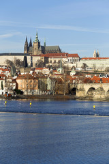 Obraz premium View on the winter Prague gothic Castle with the Charles Bridge in the sunny Day, Czech Republic