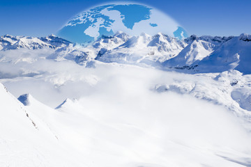 globe behind a mountain chain full of snow and a valley full of fog