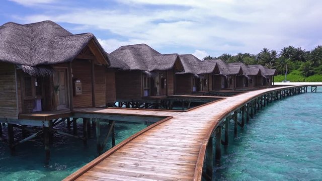 Tropical travel card with pristine beach and water bungalows at maldivian island