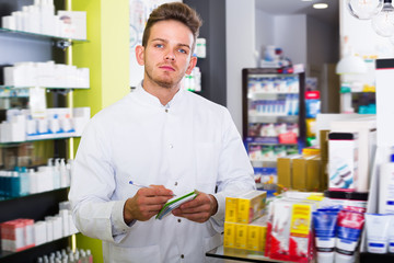 Pharmacist standing among shelves
