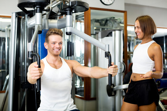 Man using pec deck gym machinery