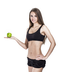 concept of a healthy lifestyle: portrait of a female fitness instructor with an Apple in his hand