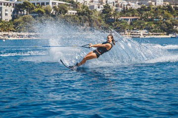 Water skis glides on the waves, female athlete on Aegean Sea,