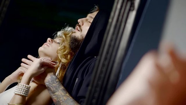 a young woman enjoys the embraces of an adult male, they smear each other with aromatic oils