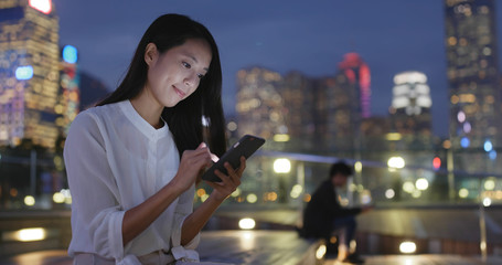 Woman use of cellphone at night