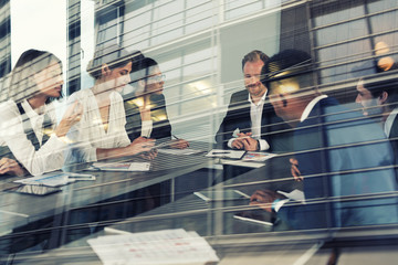 Businessmen that work together in office. Concept of teamwork, partnership and startup. double...