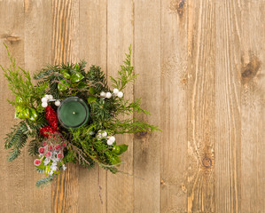 Christmas festive decoration with red baubles, holly with red berries , snow covered pine cones and winter greenery with copy space.