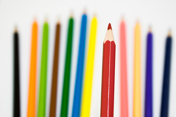 A lots of color pencil on white background, focus at red pencil color