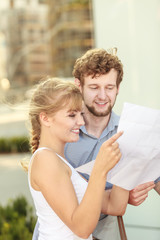 couple with blueprint project outdoor