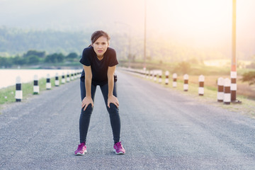 Athlete female stopped running to rest